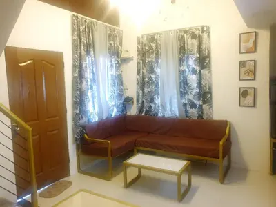 a living room with a couch and a table at Fernica Boarding House in Carmona