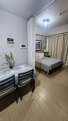 a bedroom with two beds and two benches at 4V North Wing in Manila