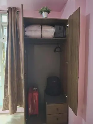 a room with a closet with luggage and a suitcase at 4V North Wing in Manila