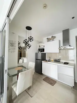 a kitchen with a glass table and a refrigerator at Condo in Paranaque Near NAIA- Azure Paranaque in Manila