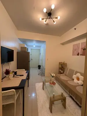 a living room with a couch and a dining room at Condomatch Staycation in Manila