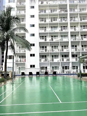 a tennis court in front of a large building at Vie Yśe - Pinterest-style Staycation Near MOA in Manila
