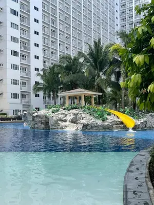 a pool with a slide in the middle of a resort at Vie Yśe - Pinterest-style Staycation Near MOA in Manila