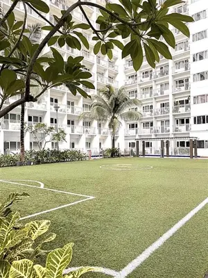 a soccer field in front of a large building at Vie Yśe - Pinterest-style Staycation Near MOA in Manila