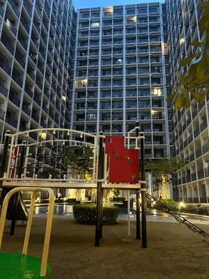 a playground in front of a tall building at Althalia Grandsuites Staycation in Manila