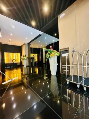 a lobby with a large mirror and plants on the floor at Relaxing Escape 2 Beds Rattan Chair & 65 inch Smart TV in Manila