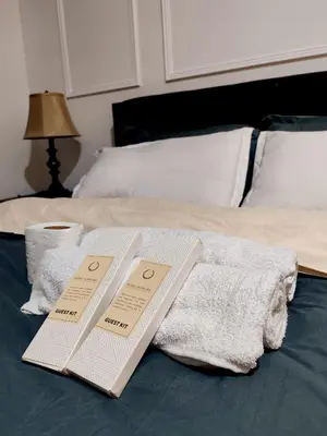 two folded towels are sitting on a bed at Azure De Joaquin in Manila