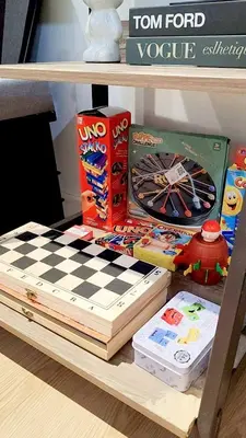 a shelf with a chess board and other toys on it at Azure De Joaquin in Manila
