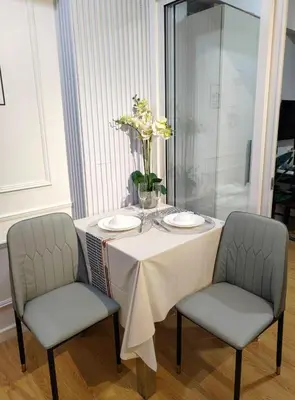 a table with two chairs and a table with two plates at Azure De Joaquin in Manila