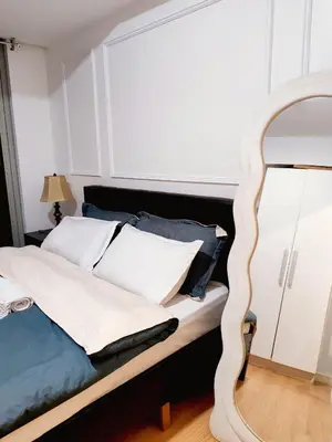 a bedroom with a bed with a mirror at Azure De Joaquin in Manila