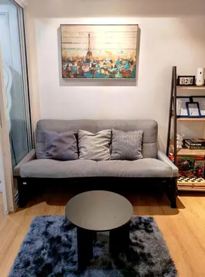 a living room with a couch and a table at Azure De Joaquin in Manila