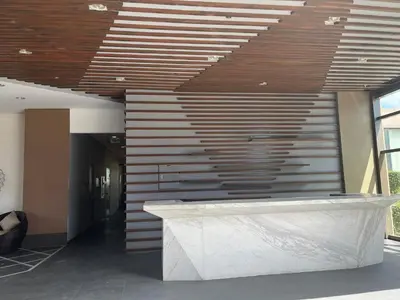 a lobby with a marble counter and wooden ceiling at Modern 1 BR Condo near Airport, MOA, PICC, Star City, OKADA With Fast WIFI & Netflix Free Pool Access in Sampong
