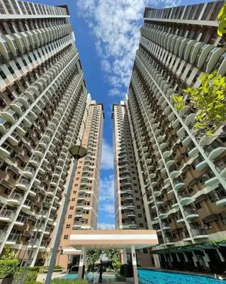 two tall buildings next to each other at Modern 1 BR Condo near Airport, MOA, PICC, Star City, OKADA With Fast WIFI & Netflix Free Pool Access in Sampong