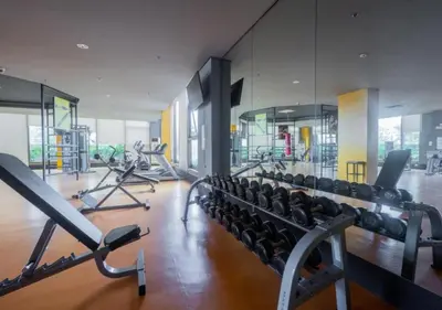 a gym with rows of treadmills and machines at Modern 1 BR Condo near Airport, MOA, PICC, Star City, OKADA With Fast WIFI & Netflix Free Pool Access in Sampong