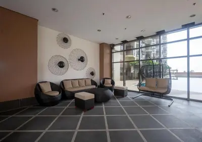 a living room with couches and chairs and windows at Modern 1 BR Condo near Airport, MOA, PICC, Star City, OKADA With Fast WIFI & Netflix Free Pool Access in Sampong