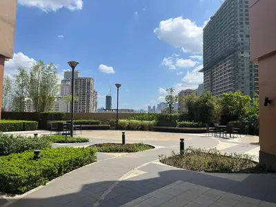 a courtyard with tables and chairs in a city at Modern 1 BR Condo near Airport, MOA, PICC, Star City, OKADA With Fast WIFI & Netflix Free Pool Access in Sampong