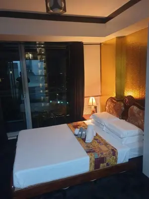 a hotel room with two beds and a window at Azure staycation miami tower in Manila
