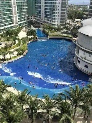 a large swimming pool in the middle of a city at Azure staycation miami tower in Manila