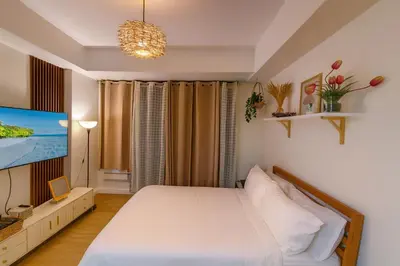 a bedroom with a bed and a flat screen tv at Azure urban residences bicutan parañaque city in Manila