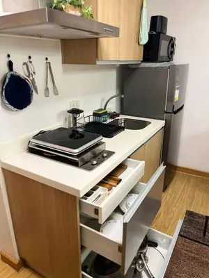 a kitchen with a sink and a stove top oven at Azure Urban Resort Residences by JEs Cabin in Manila
