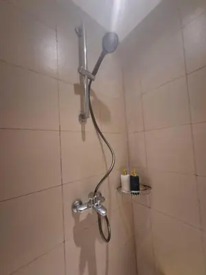 a shower with a shower head in a bathroom at Azure Urban Resort Residences by JEs Cabin in Manila