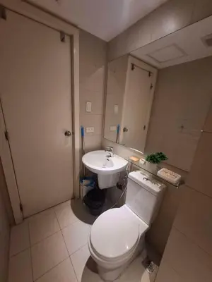 a bathroom with a toilet and a sink at Azure Urban Resort Residences by JEs Cabin in Manila