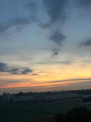a sunset over a city with a building at Azure Urban Resort Residences by JEs Cabin in Manila
