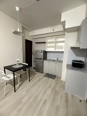 a kitchen with a table and a dining room at The Nest - Woodlands in Manila