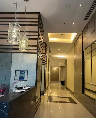 a hallway of a hotel with chandeliers at The Nest - Woodlands in Manila