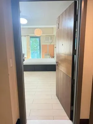 a door leading into a room with a bedroom at Palme d'Or Stay in Manila