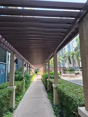 a walkway in a building with a wooden ceiling at Palme d'Or Stay in Manila