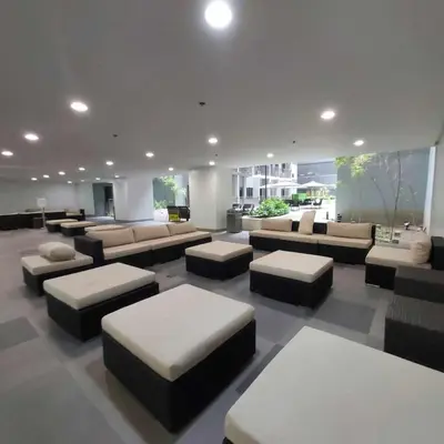 a large living room with couches and tables at 1 Bedroom in S Residences in Manila