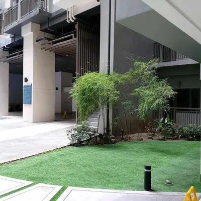 a courtyard with green grass in a building at 1 Bedroom in S Residences in Manila