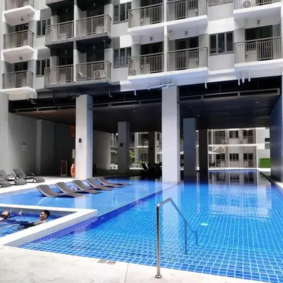 a large swimming pool in the middle of a building at 1 Bedroom in S Residences in Manila