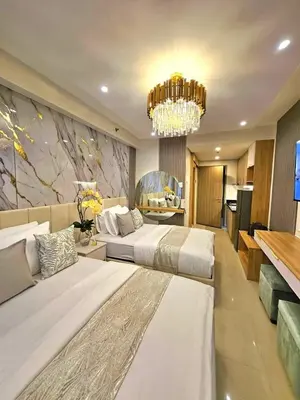 a large bedroom with two beds and a chandelier at Mk luxury suite Moa staycation twinbed in Manila