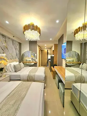 a hotel room with two beds and a chandelier at Mk luxury suite Moa staycation twinbed in Manila