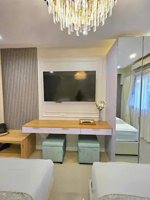 a living room with a flat screen tv and a couch at Mk luxury suite Moa staycation twinbed in Manila