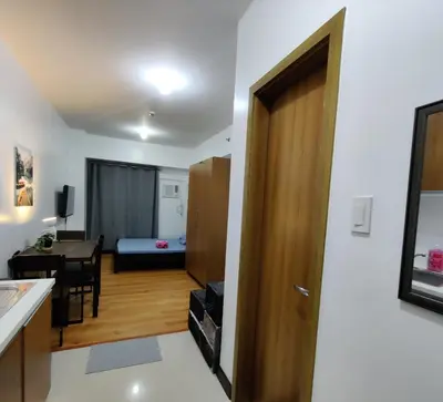 a room with a door leading to a room with a table at 8Adriatico Condo near US Embassy in Manila