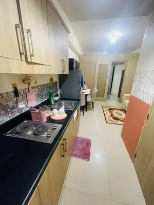 a kitchen with a sink and a counter top at Pasay City-Shore Staycation Ph in Manila