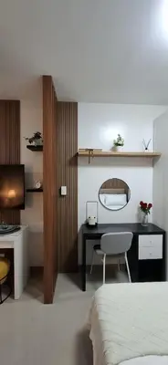 a bedroom with a bed and a desk with a chair at Shortstay at Shore 2 in Manila