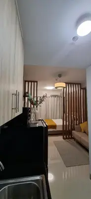 a living room with a sink and a bedroom at Shortstay at Shore 2 in Manila