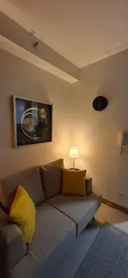 a living room with a couch and a lamp at Shortstay at Shore 2 in Manila