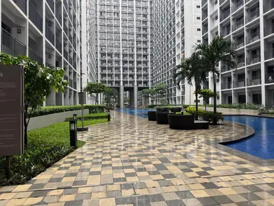 a walkway in a city with tall buildings at Shortstay at Shore 2 in Manila