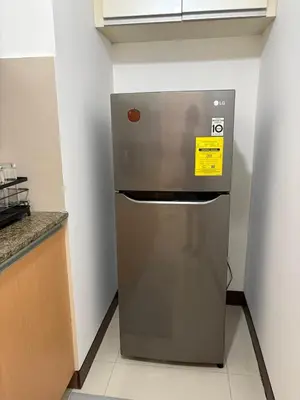 a refrigerator in the corner of a kitchen at Warm & Minimalist 1BR at Two Palm, Newport, T3 in Manila
