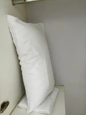 a white pillow in a corner of a room at Warm & Minimalist 1BR at Two Palm, Newport, T3 in Manila