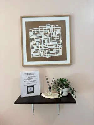 a shelf with a box and a picture on the wall at Warm & Minimalist 1BR at Two Palm, Newport, T3 in Manila