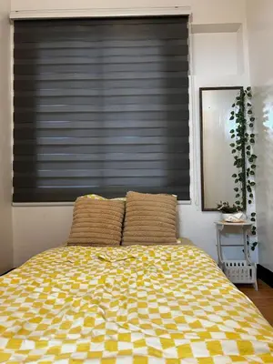 a bedroom with a bed with a black blind at Chic Haven Home away from home in Imus