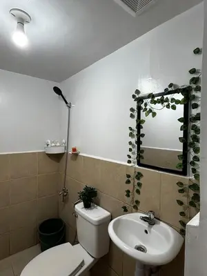 a bathroom with a toilet and a sink and a mirror at Chic Haven Home away from home in Imus