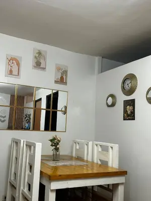a dining room with a wooden table and chairs at Chic Haven Home away from home in Imus