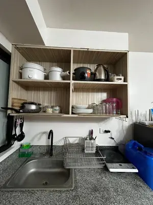 a kitchen sink with a dish drying rack next to it at Chic Haven Home away from home in Imus